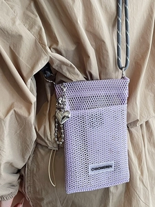 Chic purple mesh crossbody phone bag with silver heart charm and woven strap on model