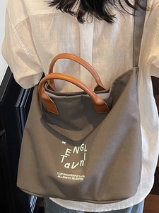 Fashionable large capacity taupe canvas tote bag with brown leather handles and embroidery