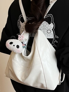 White soft PU leather tote bag with a panda plush charm shown on a female model