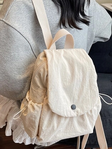 Large capacity off-white canvas backpack for students with flap cover and side pockets