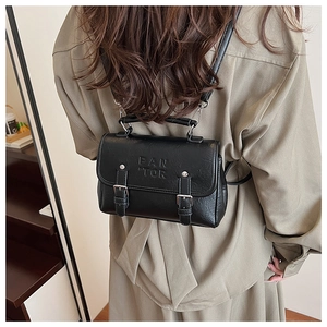 Detailed back view of a black PU leather backpack with PAN TOR embossing and adjustable straps