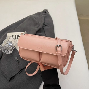 Detail of pink faux leather bag featuring embossed PARIS logo and front dual pockets