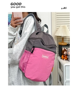 Dettaglio dello zaino casual rosa e grigio con trama a nido d'ape ed etichetta del marchio