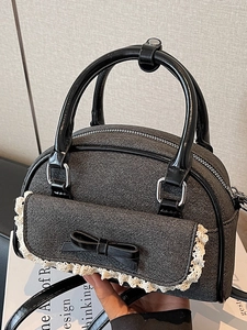 Elegant dark grey bow handbag with vintage texture and glossy black trim detail