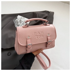 Detail of pink PU leather handbag showing buckle straps and PANTOR embossed logo