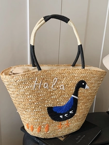 Handmade straw beach tote bag with embroidered goose pattern and Hola text for summer vacations