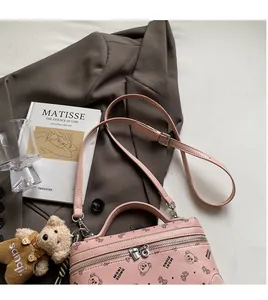 Detail of pink crossbody bag with bear prints and smooth adjustable shoulder strap