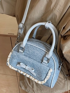 Blue bow handbag with lace trim and adjustable strap in a stylish vintage aesthetic