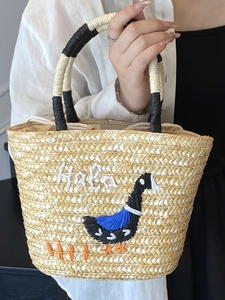 Handwoven straw tote bag with embroidered goose pattern and drawstring inner liner