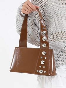Brown patent leather handbag for women featuring stylish silver studs and a sleek top handle