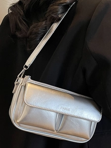 Retro silver metallic baguette bag with crackle texture and front pockets on black blazer
