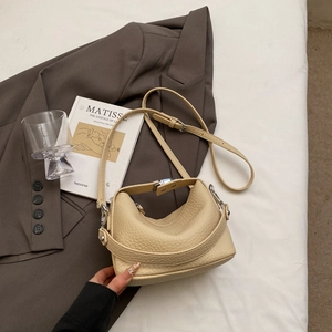 Detailed macro view of beige lychee texture leather with metal buckle and strap