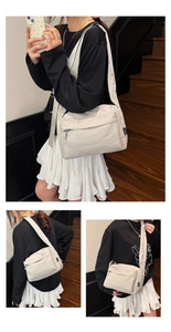 Detail view of cream nylon crossbody bag showing the wrinkled texture and wide strap