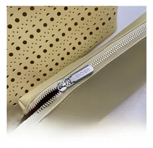Detailed macro view of the silver MIQIER branded metal zipper and premium leather texture