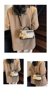 Close-up of beige crossbody bag with bear pattern and cute plush bear charm accessory