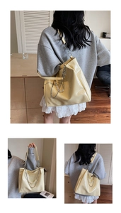 Detail of cream tote bag with crinkled texture, silver chain and pearl accents