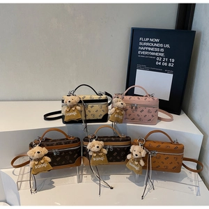Group of elegant mini vanity crossbody bags with bear charms and patterned faux leather