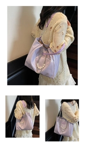 Detail of light purple tote bag in glossy grained leather with silver chain and pearl strap