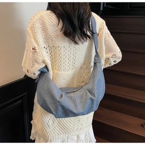 Blue denim crescent hobo bag shown from back view on model for casual everyday style