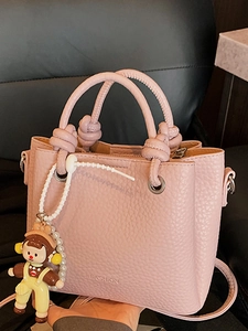 Pink lychee texture leather bucket handbag with knotted handles and pearl charm