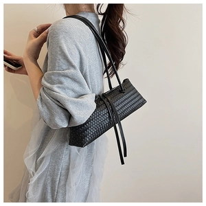 Detail of black woven leather shoulder bag showing the classic Intrecciato texture and slim straps