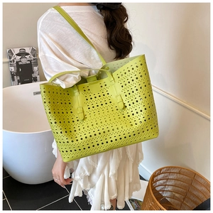 Detailed laser-cut hollow pattern on neon green large tote bag with shoulder straps