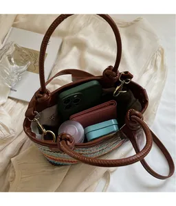 Top view of striped straw bucket bag showing spacious interior with leather handles