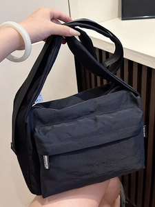 Waterproof black nylon crossbody bag with adjustable strap and front zipper pocket