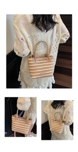 Close-up of striped straw tote bag with leather handles and woven texture details