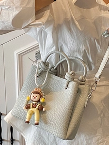 Chic light blue lychee pattern tote bag with knotted handle and cute cartoon charm
