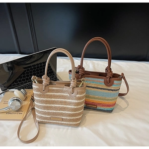 Detailed close-up of woven straw bucket bags with knotted handles and slim leather straps