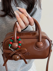 Coffee brown glossy patent leather pillow bag with stylish bow and bead pendant accessory