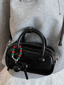 Chic black patent leather boston bag with beaded charm and adjustable strap for women