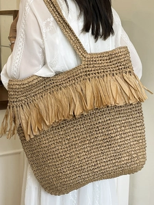 Large straw tote bag with boho fringe tassels, perfect for summer beach and vacation