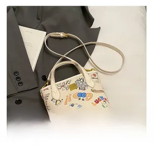 Detail of white graffiti mini tote bag featuring colorful art and gold square buckle