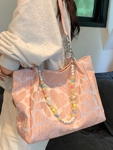 Pink heart-patterned tote bag with colorful beaded chain and silver metal strap