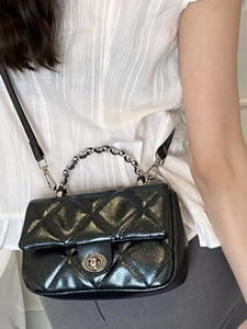 Chic black quilted crossbody bag with shimmer finish and chain handle for women