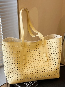 Pale yellow hollow out tote bag with geometric laser cut patterns and dual shoulder straps