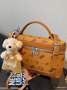 Brown leather crossbody bag with bear pattern and plush bear charm for women