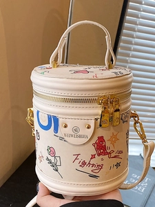 Minimalist white bucket bag with colorful graffiti illustrations and gold zipper accents
