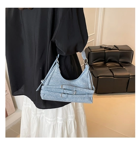 Détail du sac croissant bleu clair style moto avec boucles argentées et anneaux métal