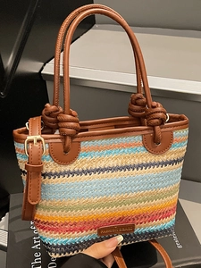 Colorful striped straw bucket bag with brown leather handles and adjustable shoulder strap