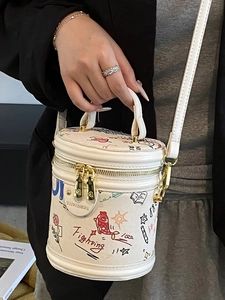 White canvas bucket bag with colorful cartoon graffiti and adjustable shoulder strap