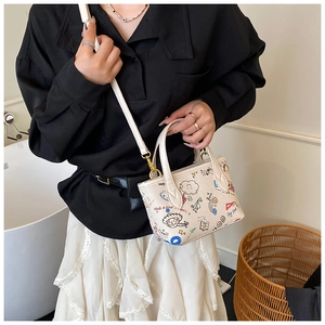 Detail of cute cartoon graffiti bucket bag with rainbow prints and adjustable shoulder strap