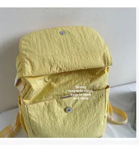 Detail of light yellow backpack with strong magnetic closure for easy opening and closing