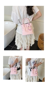 Macro detail of pink pleated bucket bag with purple gradient pearl pendant decoration