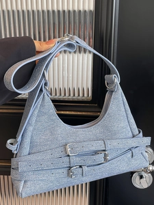 Sac croissant bleu clair texture denim avec boucles argentées et style rétro moto