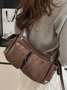 Vintage brown glossy multi-pocket shoulder bag with adjustable strap and retro design