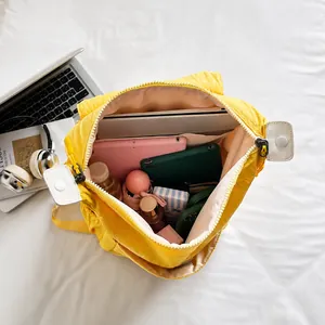 Top view of yellow canvas backpack showing spacious internal storage for laptop and items