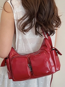 Red glossy patent leather shoulder bag with multiple pockets in retro Y2K style